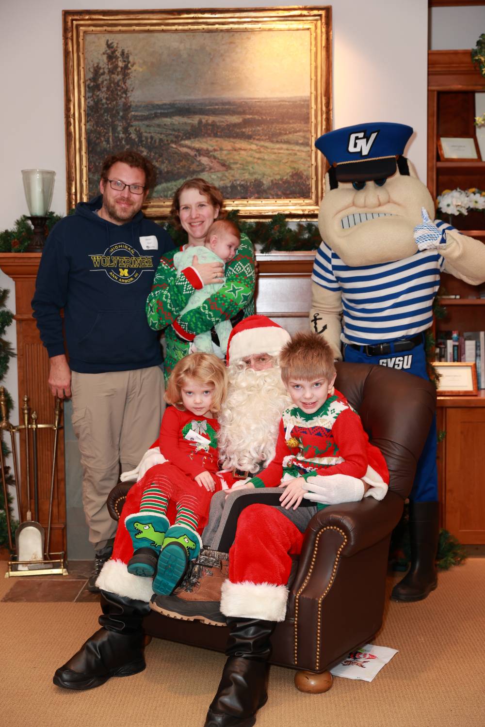 A family of five sitting with Santa & Louie.
